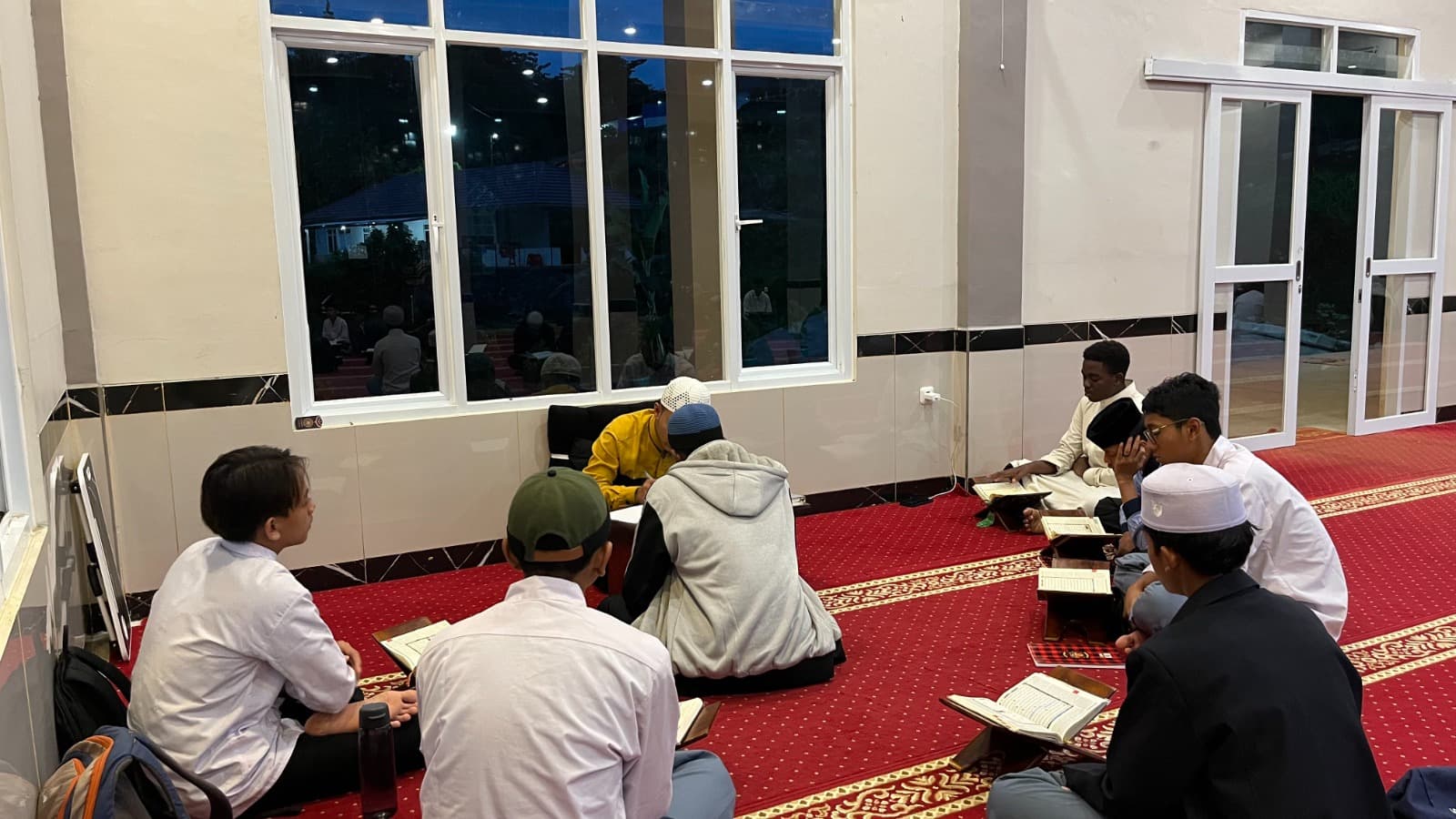 Halaqah tahfizh malam santri MA Wadi Mubarak di sisi jendela masjid kampus