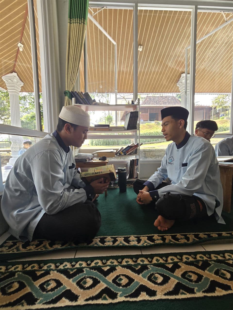 Dua santri Program Kaderisasi Muhaffizh duduk berhadapan saat tashih bacaan satu lawan satu